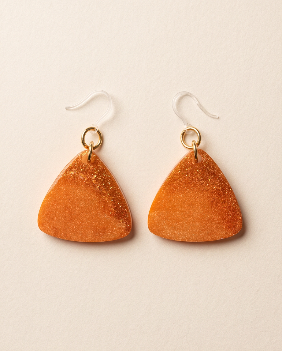 A beautiful beauty . Elevate your look with these radiant, glitter-infused earrings. Design H08 www.chakor.co.za